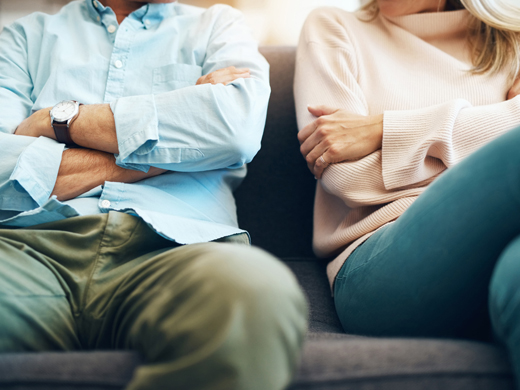 Cropped shot of a mature couple sitting on the sofa with their arms folded after an argument